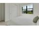 Bedroom featuring a window with neighborhood views and a closet with mirrored sliding doors at 18525 Midsummer Pl, Venice, FL 34293