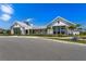 Stunning new construction clubhouse exterior with modern farmhouse design and lush landscaping at 18525 Midsummer Pl, Venice, FL 34293