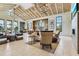 Elegant clubhouse interior featuring soaring ceilings, ample seating, and a stylish kitchen area at 18525 Midsummer Pl, Venice, FL 34293