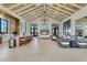 Spacious clubhouse featuring a catering kitchen, fireplace, lounge seating, and a beautiful beamed ceiling at 18525 Midsummer Pl, Venice, FL 34293