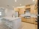 Spacious kitchen boasts a large island with seating, gas cooktop, and stainless appliances at 18525 Midsummer Pl, Venice, FL 34293
