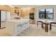 Bright kitchen features a large island, modern appliances, and a dining table with seating at 18525 Midsummer Pl, Venice, FL 34293