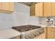 Gourmet gas range cooktop with sleek stainless steel range hood and modern appliances at 18525 Midsummer Pl, Venice, FL 34293
