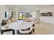 Bright living area featuring tile floors, large sliding glass doors, and an open design concept at 18525 Midsummer Pl, Venice, FL 34293