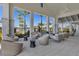 Covered patio featuring stylish wicker seating and views of the lush landscaping and pool area at 18525 Midsummer Pl, Venice, FL 34293