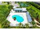 Community amenities from above: clubhouse, pool, tennis courts, and meticulously landscaped grounds at 1907 Woodleaf Hammock Ct, Bradenton, FL 34211