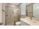 Bathroom with glass-enclosed shower, bright vanity, and modern fixtures at 1907 Woodleaf Hammock Ct, Bradenton, FL 34211