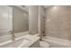 Modern bathroom featuring a granite vanity, toilet, and tiled shower-tub combo at 1907 Woodleaf Hammock Ct, Bradenton, FL 34211