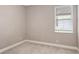 Cozy bedroom with neutral carpeting and one window allowing natural light, offering a simple and comfortable space at 1907 Woodleaf Hammock Ct, Bradenton, FL 34211