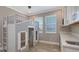 Unique bedroom featuring custom built-in bunk with playhouse and adjacent cabinets with countertops at 1907 Woodleaf Hammock Ct, Bradenton, FL 34211