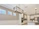 Open-concept dining area featuring stylish modern lighting, large windows, and easy access to a well-appointed kitchen at 1907 Woodleaf Hammock Ct, Bradenton, FL 34211