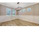 Well-lit dining room with chair rail, and light-colored wood-look flooring creating a cozy atmosphere for meals at 1907 Woodleaf Hammock Ct, Bradenton, FL 34211