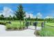 Community dog park with fenced area, picnic tables, and lush green space for recreation at 1907 Woodleaf Hammock Ct, Bradenton, FL 34211