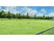 Community dog park featuring a fenced area and lush green space under a bright, sunny sky. The perfect place for your furry friend at 1907 Woodleaf Hammock Ct, Bradenton, FL 34211