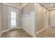 Welcoming entryway featuring modern tile flooring, coat hooks, and decorative door at 1907 Woodleaf Hammock Ct, Bradenton, FL 34211