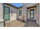 Covered front entrance featuring brick pavers, stone accents, and decorative front door at 1907 Woodleaf Hammock Ct, Bradenton, FL 34211