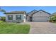 Beautiful single-Gathering home with a brick driveway, well-kept lawn, and stone accents at 1907 Woodleaf Hammock Ct, Bradenton, FL 34211