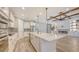 Open kitchen and living space featuring a large island, fireplace, and stainless steel appliances at 1907 Woodleaf Hammock Ct, Bradenton, FL 34211