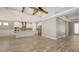 Bright, modern kitchen with stainless steel appliances, large island, and beautiful wood-look tile floors at 1907 Woodleaf Hammock Ct, Bradenton, FL 34211