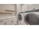 Well-equipped laundry room featuring modern washer/dryer and ample storage at 1907 Woodleaf Hammock Ct, Bradenton, FL 34211
