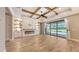 Bright living room with custom built-ins, fireplace, and sliding glass doors overlooking the pool at 1907 Woodleaf Hammock Ct, Bradenton, FL 34211