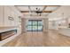 Spacious living room with fireplace, tray ceiling, and sliding glass doors to the backyard at 1907 Woodleaf Hammock Ct, Bradenton, FL 34211