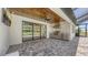 Covered outdoor kitchen with stainless steel appliances, marble backsplash, and patio at 1907 Woodleaf Hammock Ct, Bradenton, FL 34211