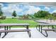 Shaded picnic tables overlooking a playground offer a relaxing area for families to enjoy outdoor activities at 1907 Woodleaf Hammock Ct, Bradenton, FL 34211