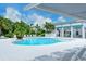 Community pool with a shaded seating area and a convenient grilling area for poolside gatherings at 1907 Woodleaf Hammock Ct, Bradenton, FL 34211