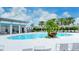 Community swimming pool featuring a covered seating area and lounge chairs perfect for relaxation at 1907 Woodleaf Hammock Ct, Bradenton, FL 34211