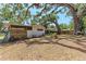 Spacious backyard with mature trees, privacy fence, and a view of the back of the property at 209 29Th Nw St, Bradenton, FL 34205