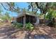 Backyard featuring mature trees, fencing, and a view of the home's screened-in patio at 209 29Th Nw St, Bradenton, FL 34205
