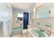 Bright bathroom featuring matching sink and bathtub, patterned floors, and good natural light at 209 29Th Nw St, Bradenton, FL 34205
