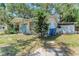 Charming single-story home with a covered porch, a bay window, and mature landscaping, set under a canopy of trees at 209 29Th Nw St, Bradenton, FL 34205
