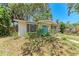 Inviting single-story home with a covered porch, white brick, bay window, and blue door, surrounded by mature landscaping at 209 29Th Nw St, Bradenton, FL 34205