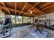 A fully screened outdoor patio including exercise equipment, ceiling fan, and a table with chairs at 209 29Th Nw St, Bradenton, FL 34205