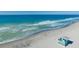 Aerial view of the beach and waves with a lifeguard stand at 210 Santa Maria St # 244, Venice, FL 34285