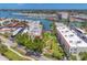 Aerial view of the condo complex with a manicured lawn and sidewalks, close to the water and marina at 210 Santa Maria St # 244, Venice, FL 34285