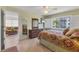 A cozy bedroom features beautiful tile floors, a ceiling fan and comfortable furniture at 210 Santa Maria St # 244, Venice, FL 34285