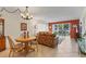Cozy dining area with round table and view into the adjacent living room at 210 Santa Maria St # 244, Venice, FL 34285
