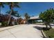 View of entrance with tropical plants and a covered passageway to the beach at 210 Santa Maria St # 244, Venice, FL 34285