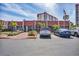 Entrance to condo building with covered entrance, parking, and mature palm tree landscaping at 210 Santa Maria St # 244, Venice, FL 34285