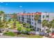 Exterior view of condo complex featuring manicured landscaping, sidewalks, and direct waterfront access at 210 Santa Maria St # 244, Venice, FL 34285