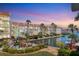 Waterfront condo with boat docks, palm trees, and inviting outdoor seating areas at 210 Santa Maria St # 244, Venice, FL 34285