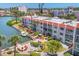 Waterfront condo featuring a boat slip, outdoor seating area with fire pit, and tropical landscaping at 210 Santa Maria St # 244, Venice, FL 34285