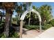 Entrance to the Venice Fishing Pier, with lush tropical landscaping and a brick-paved walkway at 210 Santa Maria St # 244, Venice, FL 34285