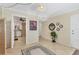Hallway view with tile flooring leading to the kitchen and other rooms at 210 Santa Maria St # 244, Venice, FL 34285