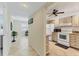 Bright kitchen featuring white appliances and tile floors at 210 Santa Maria St # 244, Venice, FL 34285
