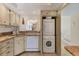 Convenient kitchen with built-in laundry machines and granite countertops at 210 Santa Maria St # 244, Venice, FL 34285