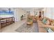 Bright living room with tile flooring, patterned rug, and wicker furniture at 210 Santa Maria St # 244, Venice, FL 34285